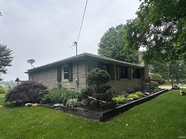 32131 State Road 2nd Rd, New Carlisle, IN 46552 - view of side of home featuring stone siding, a yard, and a chimney