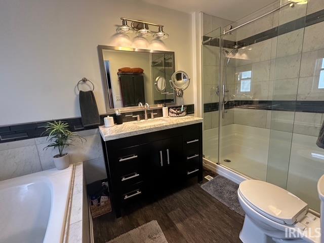 32131 State Road 2nd Rd, New Carlisle, IN 46552 - bathroom featuring wood finished floors, vanity, a garden tub, and a shower stall