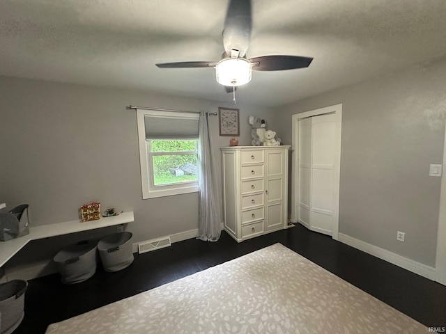 32131 State Road 2nd Rd, New Carlisle, IN 46552 - bedroom with dark wood-type flooring, a desk, ceiling fan, and a closet