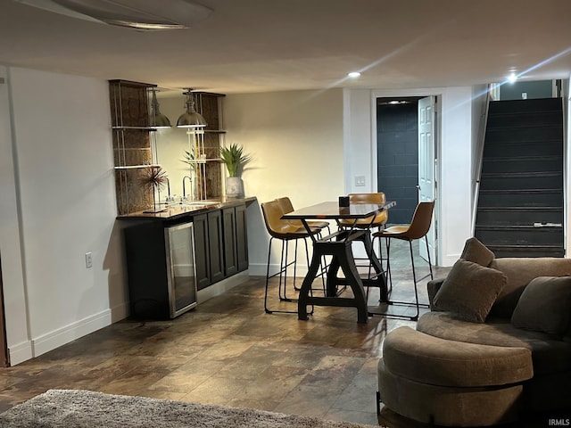 32131 State Road 2nd Rd, New Carlisle, IN 46552 - dining space with bar with sink, stairs, dark stone finish floors, and recessed lighting