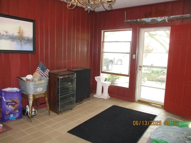 8487 N Old Highway 231st Rd, Linden, IN 47955 - entryway featuring tile patterned floors, a chandelier, and wood walls