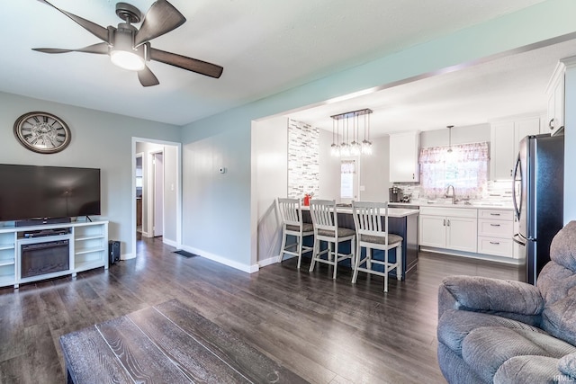 1703 Frantz Dr, North Manchester, IN 46962 - living room featuring ceiling fan and dark wood-style floors