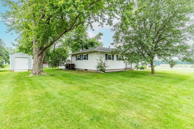 1703 Frantz Dr, North Manchester, IN 46962 - view of grassy yard featuring an outdoor structure and a detached garage