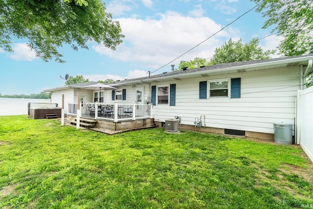 1703 Frantz Dr, North Manchester, IN 46962 - back of property featuring a hot tub, a yard, and a deck with water view