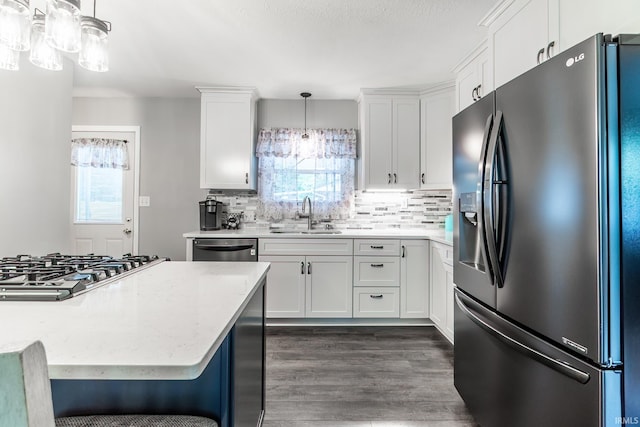 1703 Frantz Dr, North Manchester, IN 46962 - kitchen with stainless steel appliances, white cabinetry, tasteful backsplash, and dark wood finished floors