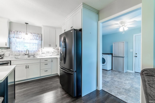 1703 Frantz Dr, North Manchester, IN 46962 - kitchen with refrigerator with ice dispenser, washer / dryer, white cabinetry, tasteful backsplash, and a textured ceiling