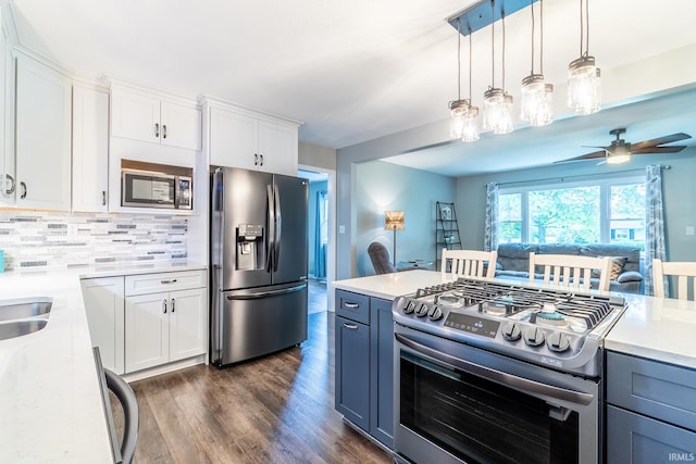 1703 Frantz Dr, North Manchester, IN 46962 - kitchen featuring appliances with stainless steel finishes, dark wood-type flooring, white cabinets, ceiling fan, and hanging light fixtures