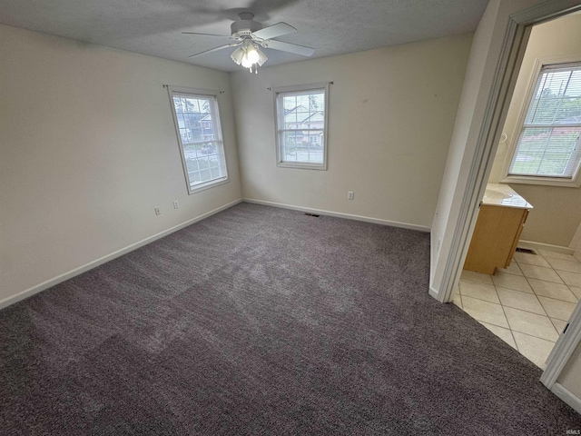 3832 E Cobble Creek Dr, Bloomington, IN 47401 - unfurnished room featuring healthy amount of natural light, a ceiling fan, light carpet, and a textured ceiling