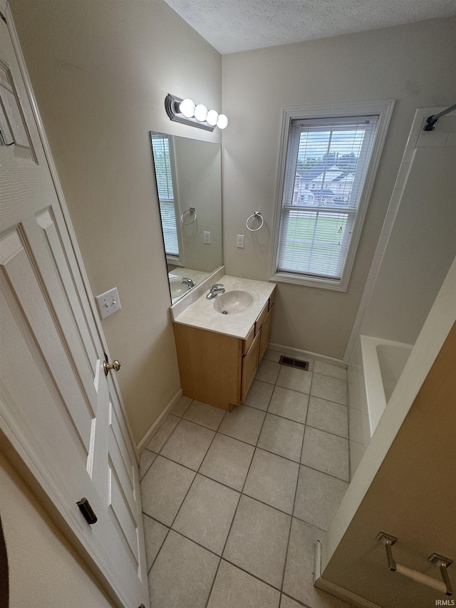 3832 E Cobble Creek Dr, Bloomington, IN 47401 - bathroom featuring tile patterned floors, vanity, a textured ceiling, and  shower combination