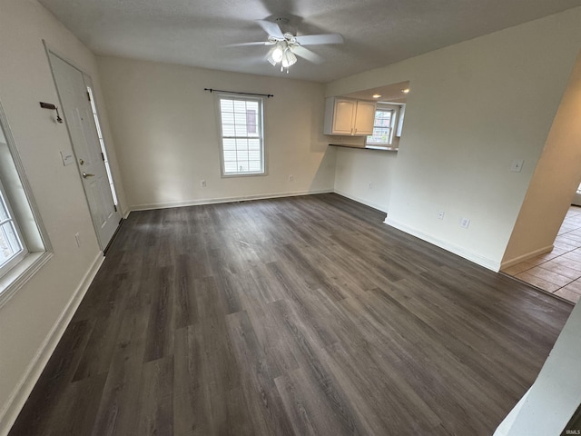 3832 E Cobble Creek Dr, Bloomington, IN 47401 - unfurnished living room with dark wood-style flooring and ceiling fan