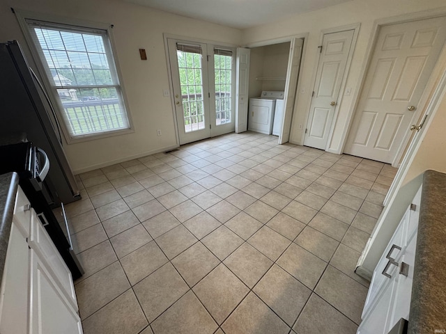 3832 E Cobble Creek Dr, Bloomington, IN 47401 - unfurnished dining area featuring washer and dryer, light tile patterned floors, and healthy amount of natural light