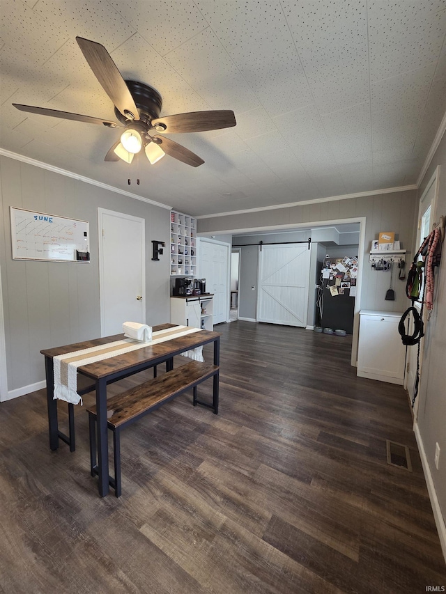 603 E 1st St, Fowler, IN 47944 - dining area with a barn door, ceiling fan, dark wood-type flooring, and ornamental molding