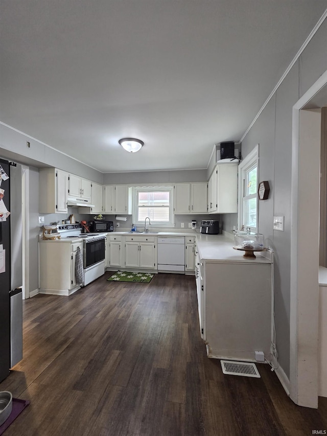603 E 1st St, Fowler, IN 47944 - kitchen with white appliances, dark wood-style floors, under cabinet range hood, plenty of natural light, and crown molding