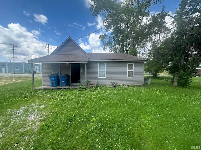126 Cook St, Jasonville, IN 47438 - rear view of property featuring a yard and a shingled roof