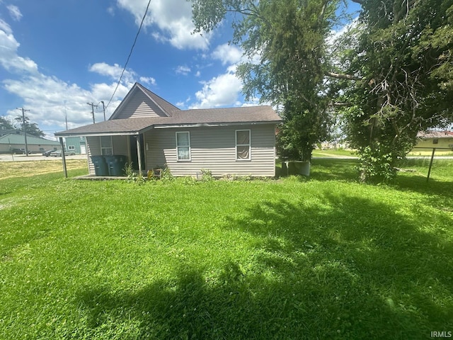 126 Cook St, Jasonville, IN 47438 - view of side of home with a lawn and a shingled roof