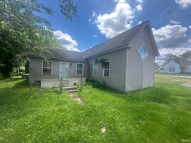 126 Cook St, Jasonville, IN 47438 - rear view of property with a yard and roof with shingles