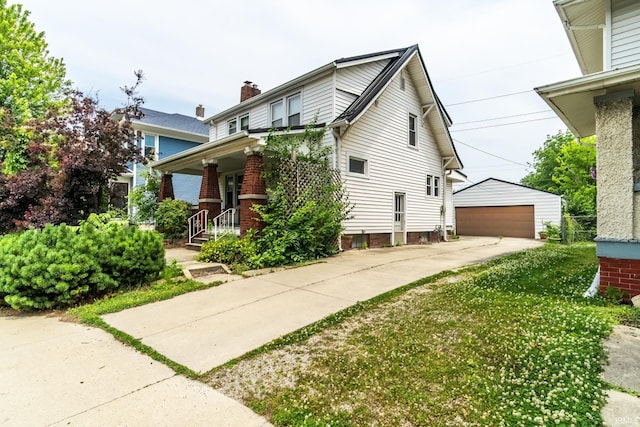 2130 N Wells St, Fort Wayne, IN 46808 - view of front of home with an outdoor structure, a chimney, a garage, and brick siding