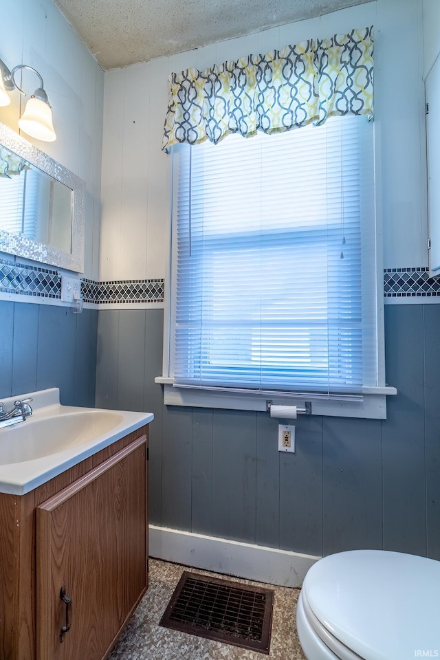 2130 N Wells St, Fort Wayne, IN 46808 - half bathroom with plenty of natural light, vanity, and a textured ceiling