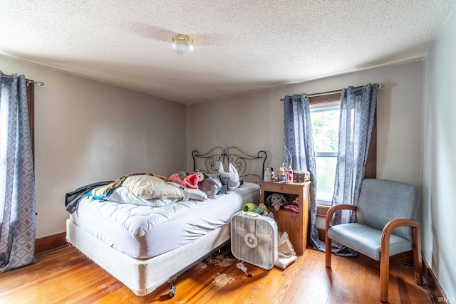 2130 N Wells St, Fort Wayne, IN 46808 - bedroom with hardwood / wood-style floors and a textured ceiling