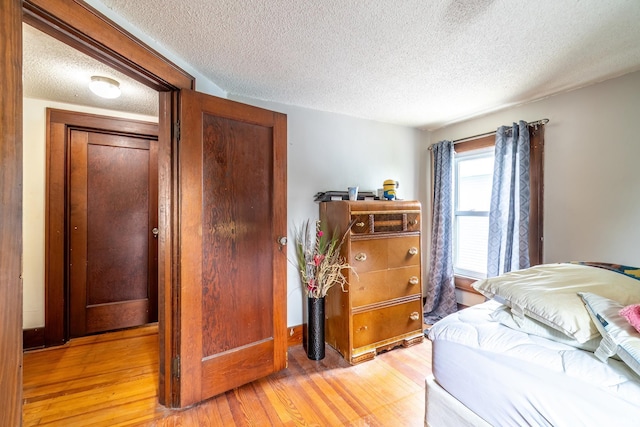 2130 N Wells St, Fort Wayne, IN 46808 - bedroom with a textured ceiling and light wood-style flooring