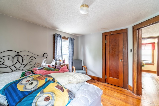 2130 N Wells St, Fort Wayne, IN 46808 - bedroom featuring a textured ceiling and light wood-style flooring