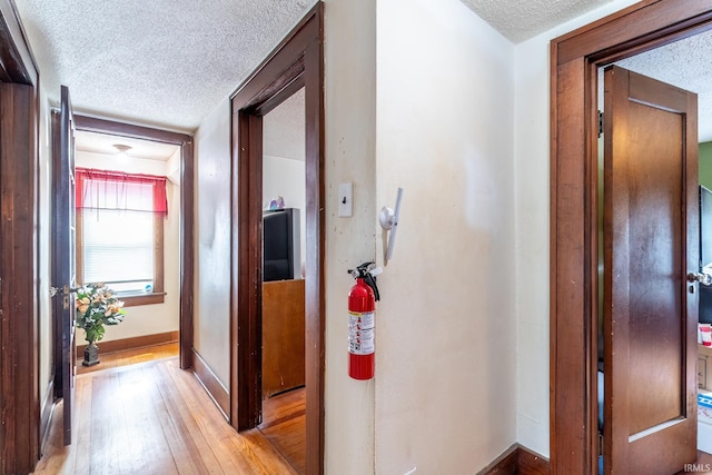 2130 N Wells St, Fort Wayne, IN 46808 - hallway featuring a textured ceiling and light wood-type flooring