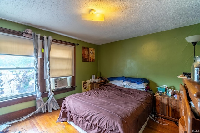 2130 N Wells St, Fort Wayne, IN 46808 - bedroom featuring cooling unit, a textured ceiling, and wood finished floors