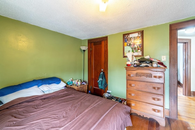 2130 N Wells St, Fort Wayne, IN 46808 - bedroom with a textured ceiling and wood finished floors