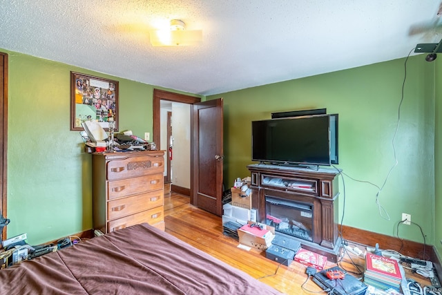 2130 N Wells St, Fort Wayne, IN 46808 - bedroom with a textured ceiling and wood finished floors