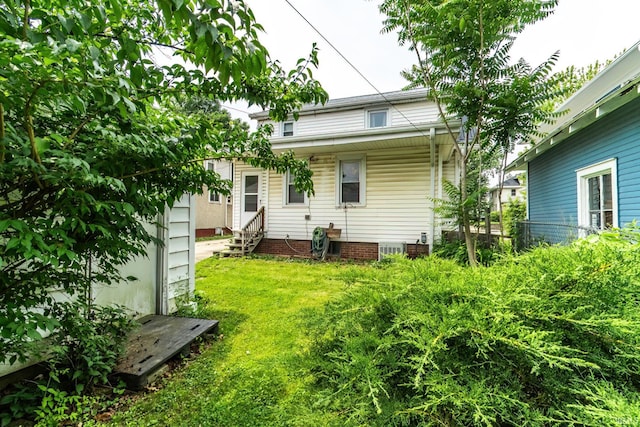 2130 N Wells St, Fort Wayne, IN 46808 - back of house featuring entry steps and a yard