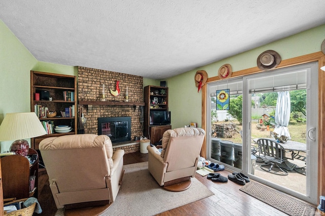 55698 Willowbend Blvd, Bristol, IN 46507 - living area featuring a textured ceiling, wood finished floors, and a fireplace