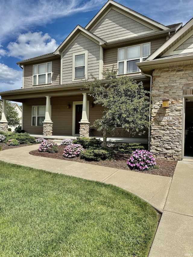3638 Swansea Dr, West Lafayette, IN 47906 - view of front facade with stone siding, a front yard, and covered porch