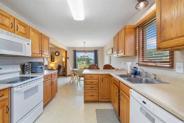 5371 Bear Creek Pass, Auburn, IN 46706 - kitchen with white appliances, light countertops, a peninsula, a chandelier, and a textured ceiling