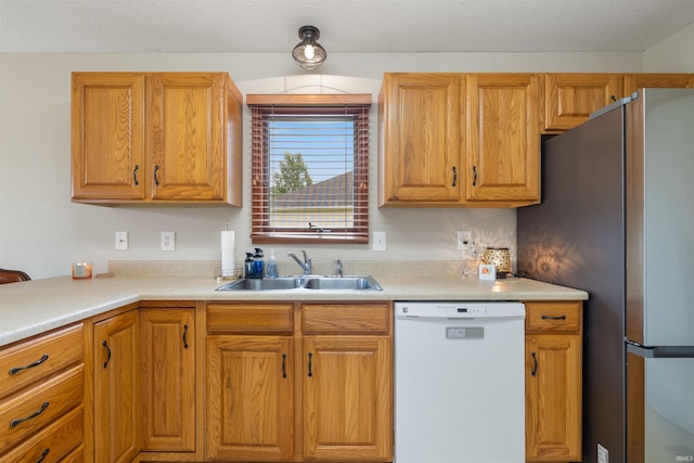 5371 Bear Creek Pass, Auburn, IN 46706 - kitchen with white dishwasher, freestanding refrigerator, light countertops, and brown cabinetry