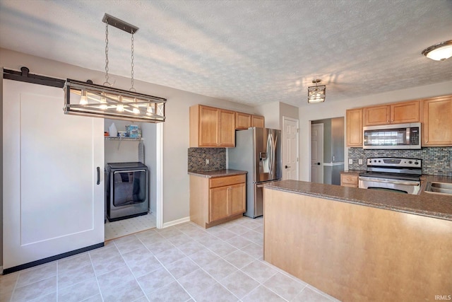 4539 N Shadow Wood Dr, Bloomington, IN 47404 - kitchen featuring appliances with stainless steel finishes, decorative backsplash, dark countertops, light tile patterned flooring, and a textured ceiling
