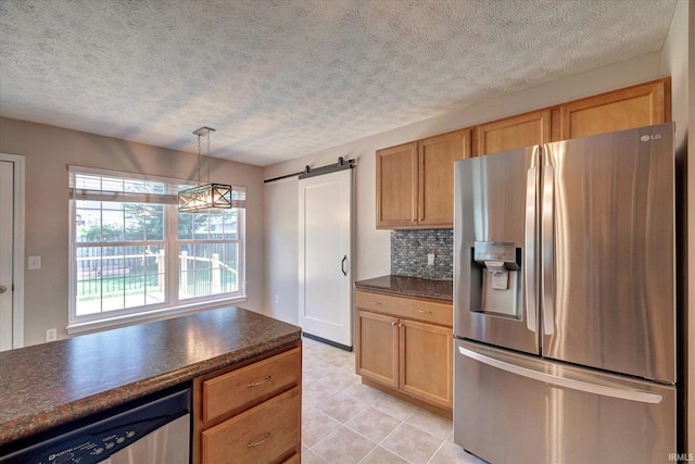 4539 N Shadow Wood Dr, Bloomington, IN 47404 - kitchen featuring stainless steel appliances, dark countertops, light tile patterned floors, a textured ceiling, and tasteful backsplash