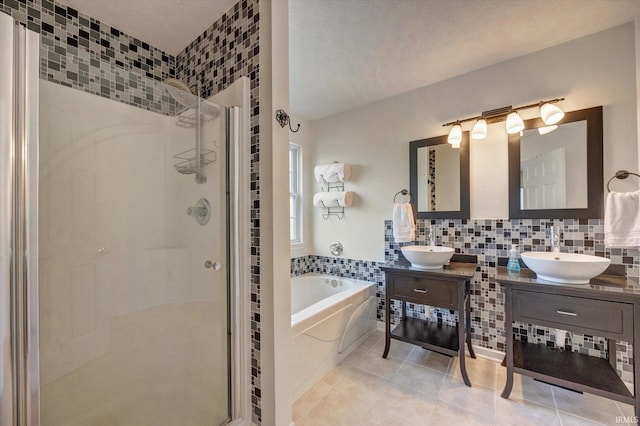 4539 N Shadow Wood Dr, Bloomington, IN 47404 - full bath featuring a shower stall, a bath, tile patterned flooring, two vanities, and tasteful backsplash
