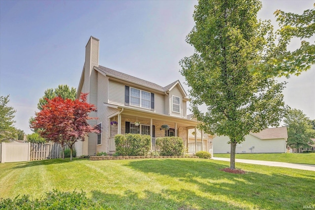4539 N Shadow Wood Dr, Bloomington, IN 47404 - traditional-style house featuring covered porch, a chimney, driveway, and a garage