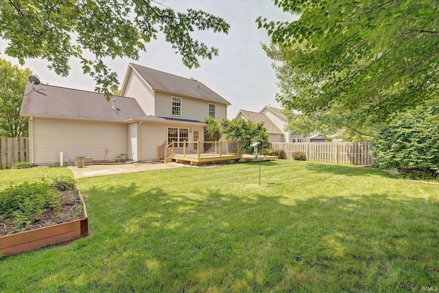 4539 N Shadow Wood Dr, Bloomington, IN 47404 - rear view of property featuring a fenced backyard, a deck, and a garden