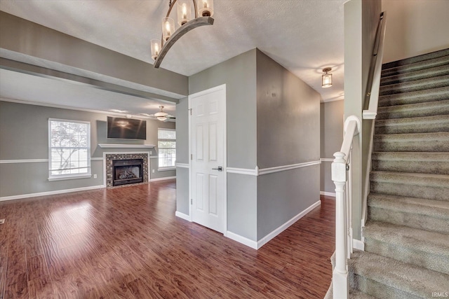 4539 N Shadow Wood Dr, Bloomington, IN 47404 - stairway with wood finished floors, a ceiling fan, and a tiled fireplace