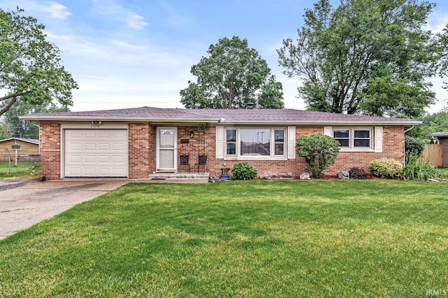 2514 Wood St, Elkhart, IN 46514 - ranch-style home with concrete driveway, brick siding, an attached garage, and a front lawn