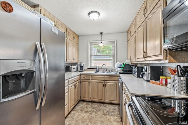2514 Wood St, Elkhart, IN 46514 - kitchen featuring appliances with stainless steel finishes, light countertops, light brown cabinets, and a textured ceiling