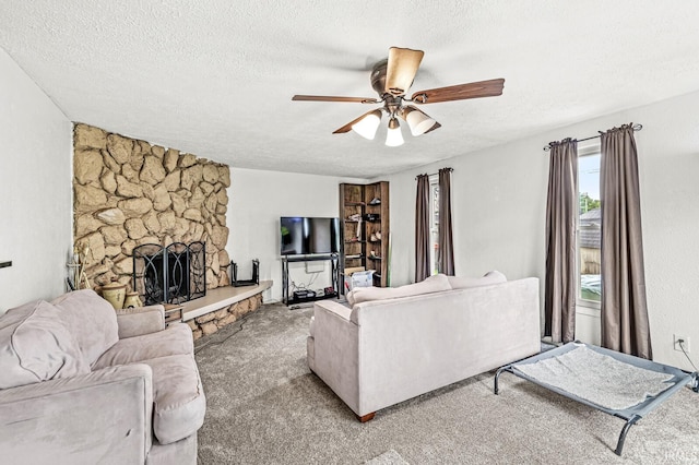 2514 Wood St, Elkhart, IN 46514 - living area with carpet floors, a ceiling fan, a textured ceiling, and a stone fireplace