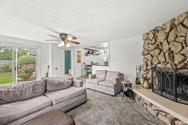 2514 Wood St, Elkhart, IN 46514 - carpeted living area with a textured ceiling, a stone fireplace, and ceiling fan