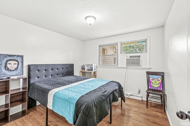 2514 Wood St, Elkhart, IN 46514 - bedroom featuring wood finished floors, a textured ceiling, and cooling unit