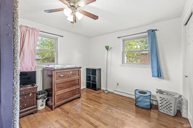 2514 Wood St, Elkhart, IN 46514 - bedroom with a baseboard heating unit, light wood finished floors, a closet, and ceiling fan