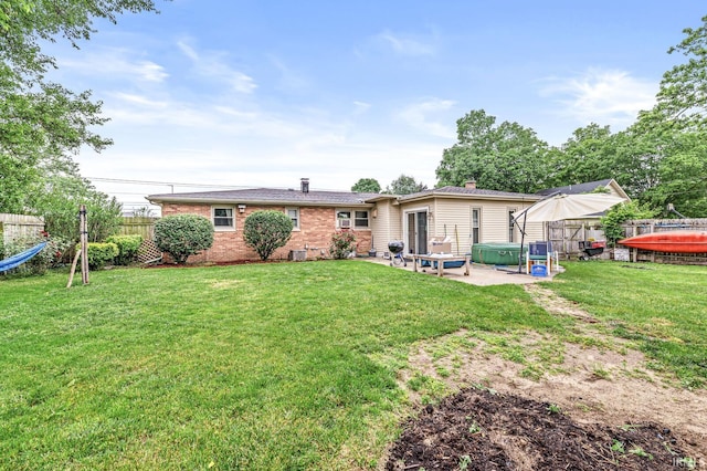 2514 Wood St, Elkhart, IN 46514 - rear view of property with a patio area, brick siding, and a jacuzzi