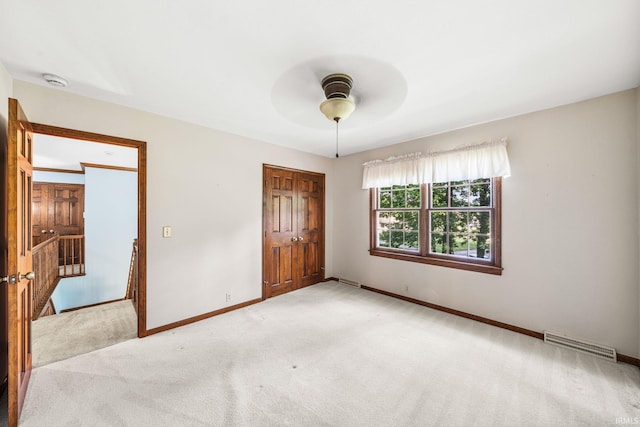 17112 Ridgefield Ct, Granger, IN 46530 - unfurnished bedroom with carpet flooring, a closet, and a ceiling fan