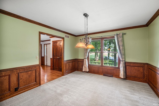17112 Ridgefield Ct, Granger, IN 46530 - carpeted empty room featuring wainscoting, crown molding, wood walls, and a chandelier