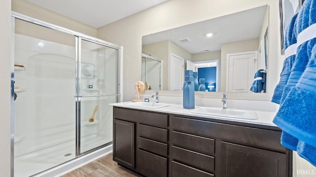 12967 Solo Ln, Fort Wayne, IN 46818 - bathroom with a stall shower, double vanity, and wood finished floors